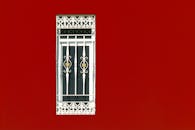 Photo of a Window on a Red Wall