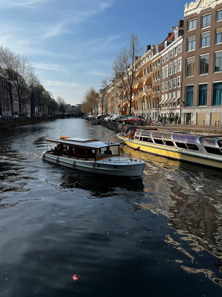 Canoe On Water Canal Near Old Buildings 