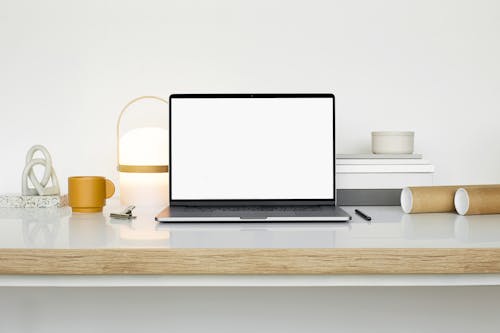 Free Laptop on White Wooden Table Stock Photo