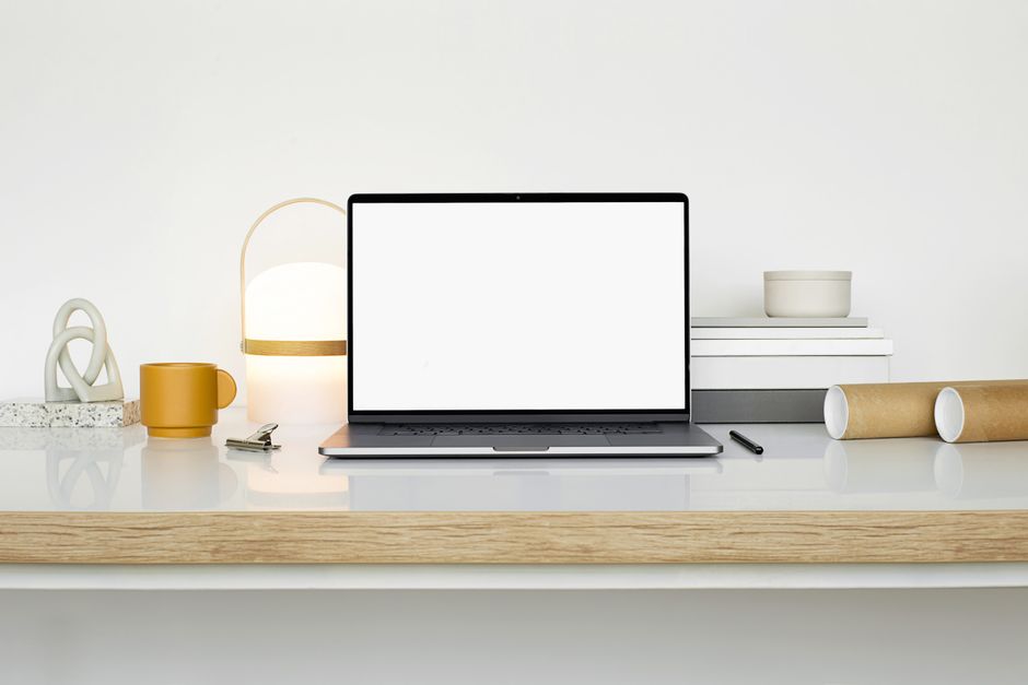 Baby Brezza Formula Pro Advanced vs Manual Bottle Prep: Safety and Convenience Explored Sleek workspace setup featuring a laptop, mug, and decor on a white desk.
