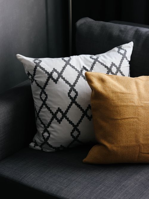 Free Close-up of comfy cushions on a modern sofa, showcasing a chic geometric design. Stock Photo