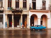 Blue Car Parked Beside Brown Concrete Building