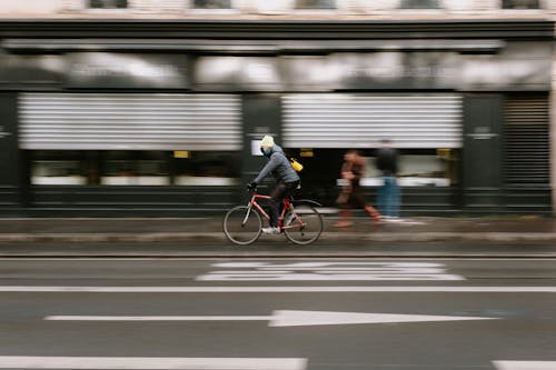 A Man Riding on a Fast Moving Bicycle