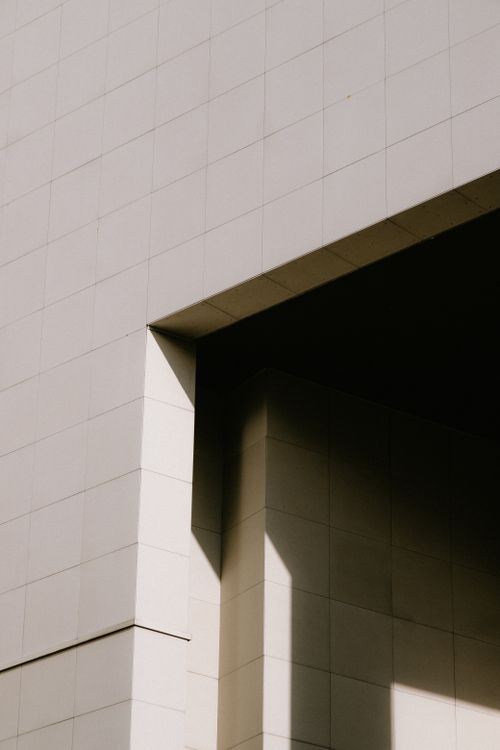 Free Abstract view of a modern building with geometric shadows and smooth tiles. Stock Photo
