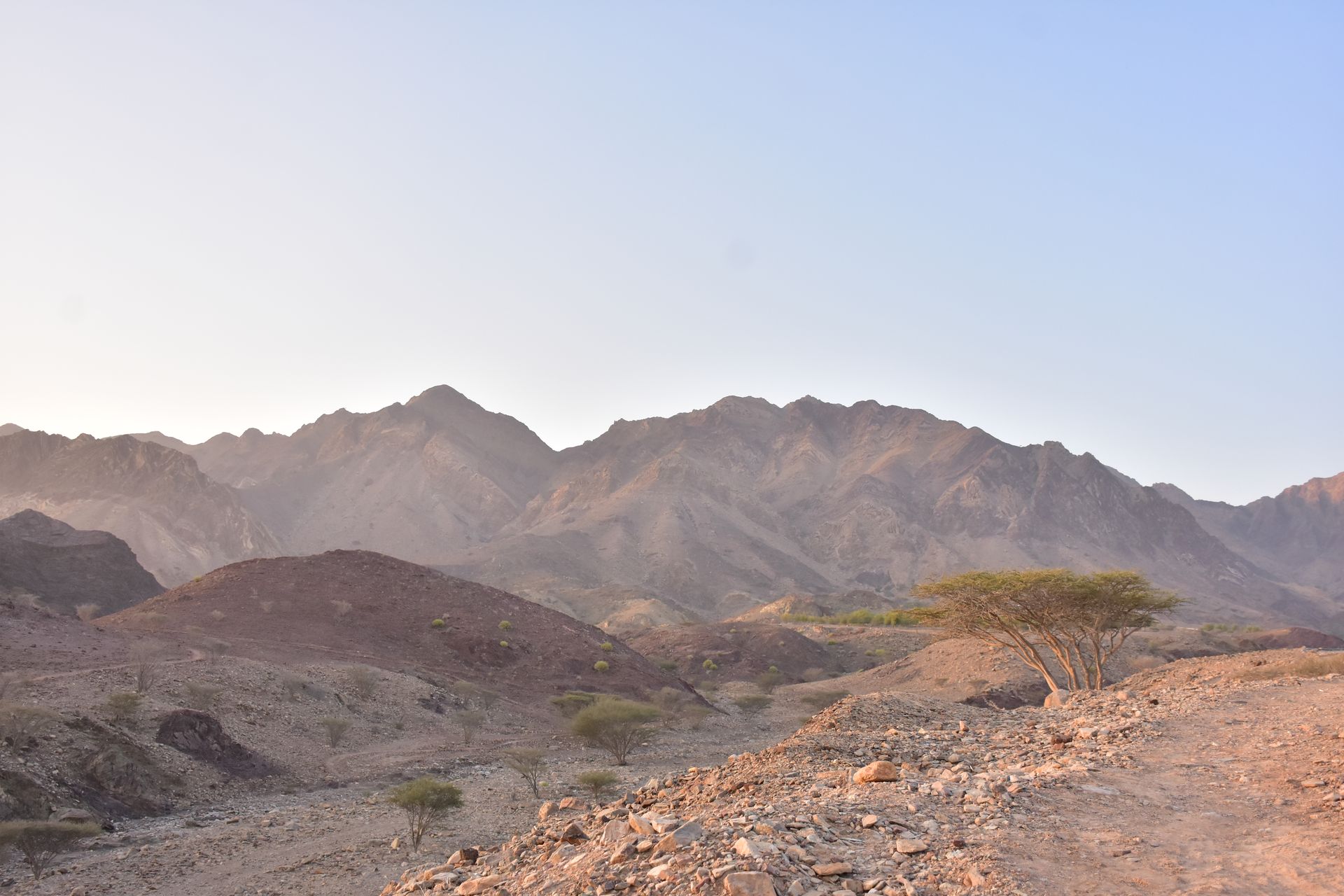 Explore the serene beauty of Hatta's desert mountains at sunrise, capturing natural wonder.