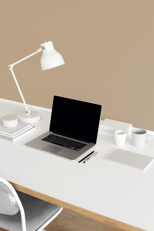Laptop on White Desk with Chair