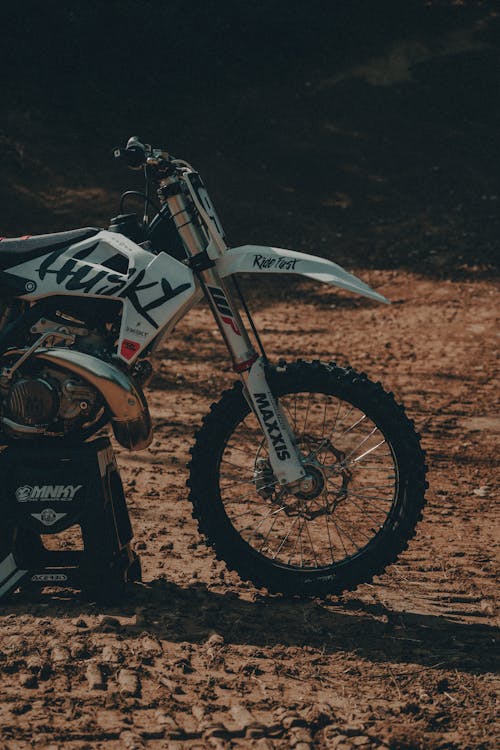 Black and White Motocross Dirt Bike on a Muddy Ground