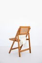 Brown Wooden Folding Chair on White Floor
