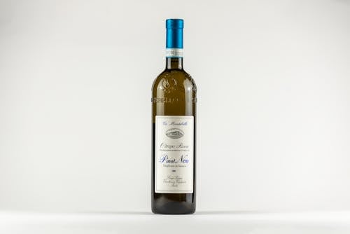 Free A Bottle of White Wine on White Surface Stock Photo