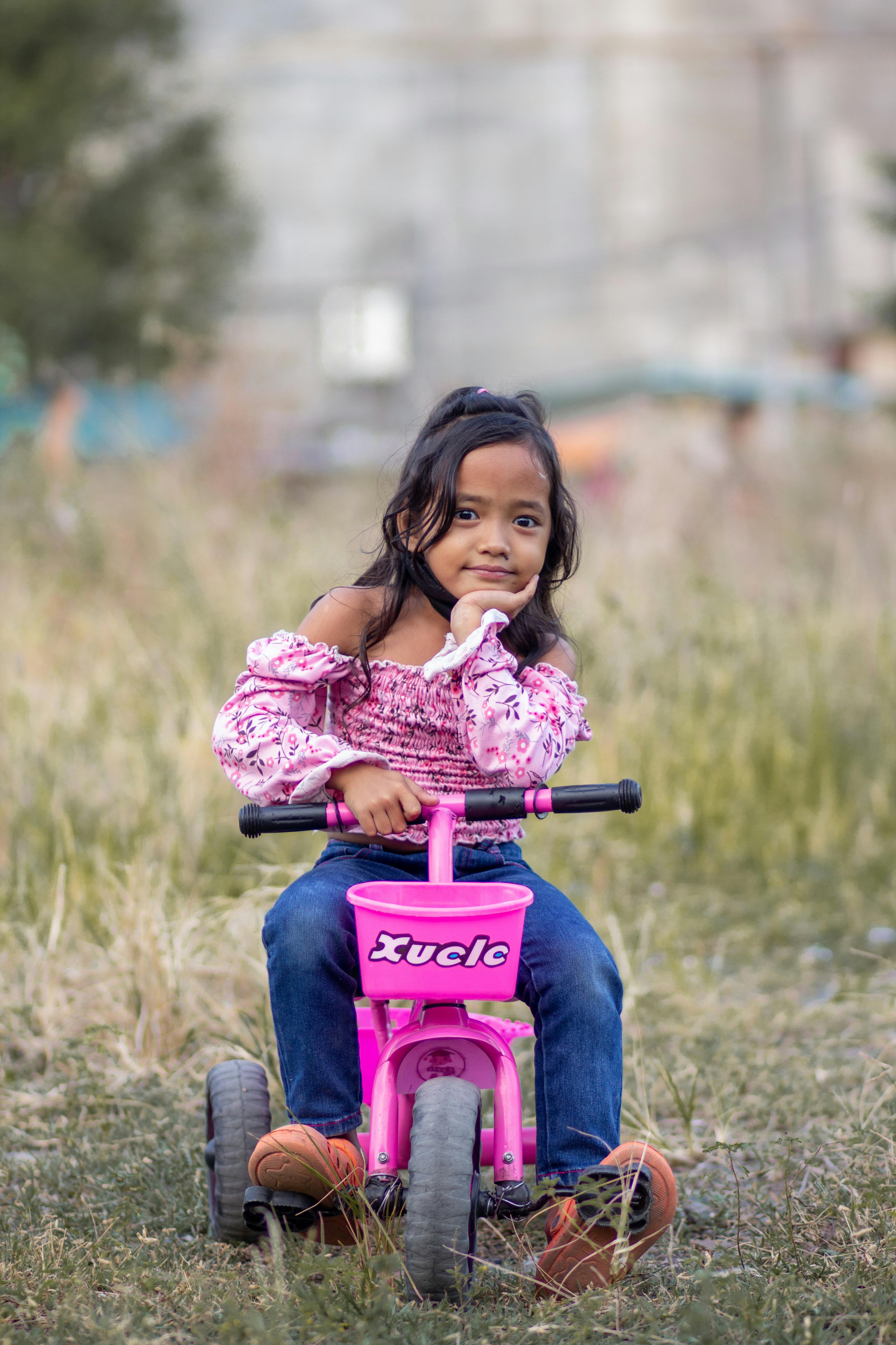 Girl Riding Toy Bike · Free Stock Photo