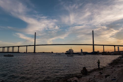 Suspension Bridge over a River during Dusk 