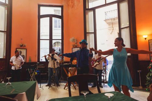 Free A vibrant indoor scene of musicians and dancers performing together in a cozy cafe setting. Stock Photo