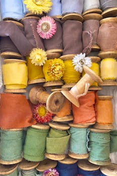 A vibrant collection of fabric rolls in various colors adorned with flower heads.