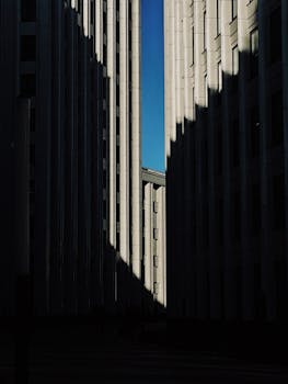 A dramatic view of skyscrapers with shadows, enhancing urban architecture vibes.