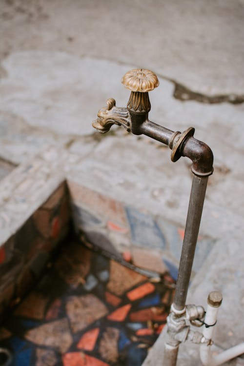 Selective Focus Photo of an Outdated Faucet 