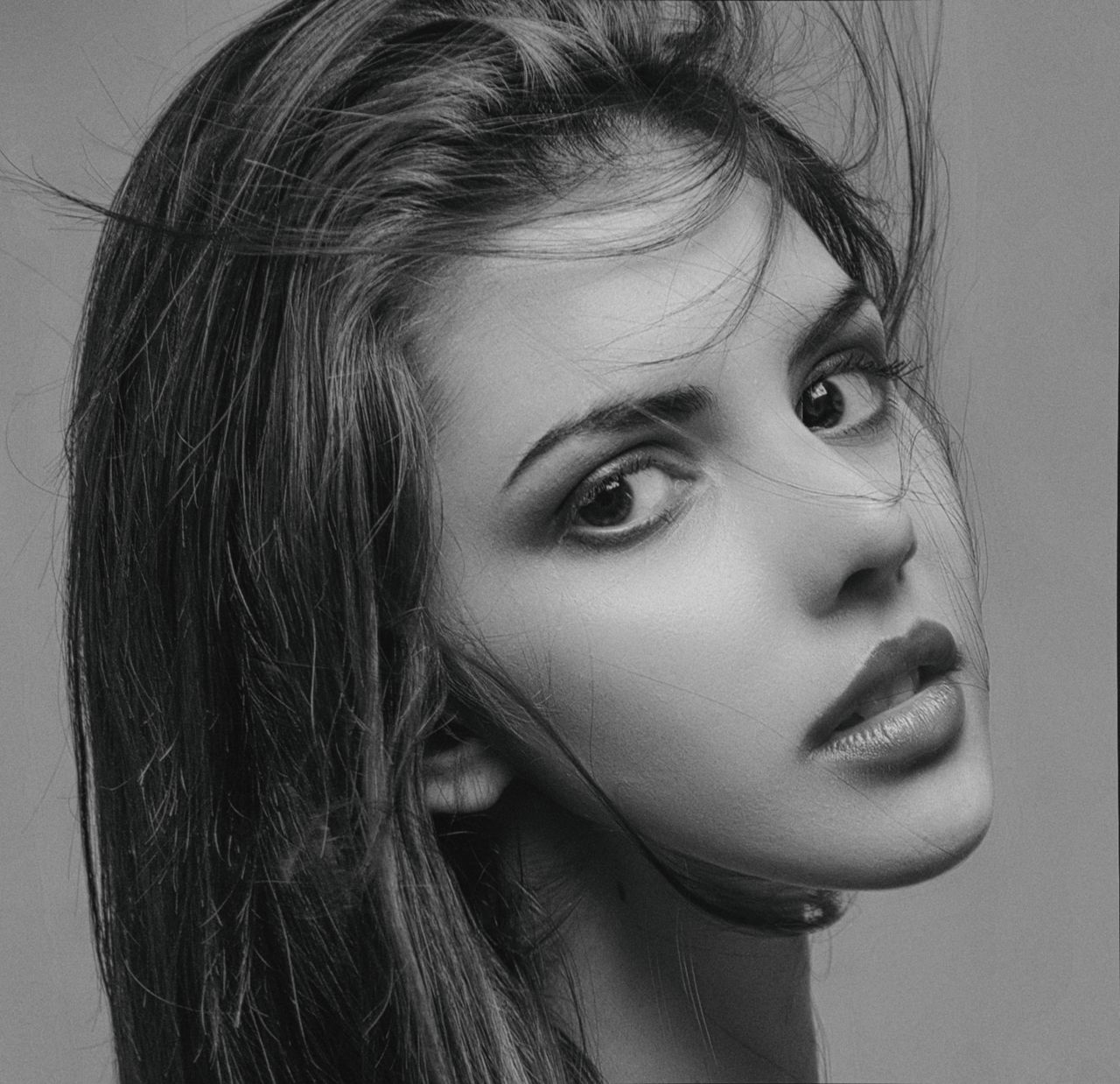 elegant black and white close up of a woman with expressive eyes and f