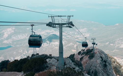 Free Cable cars traverse over rugged mountains in Fethiye, offering breathtaking views of the landscape. Stock Photo