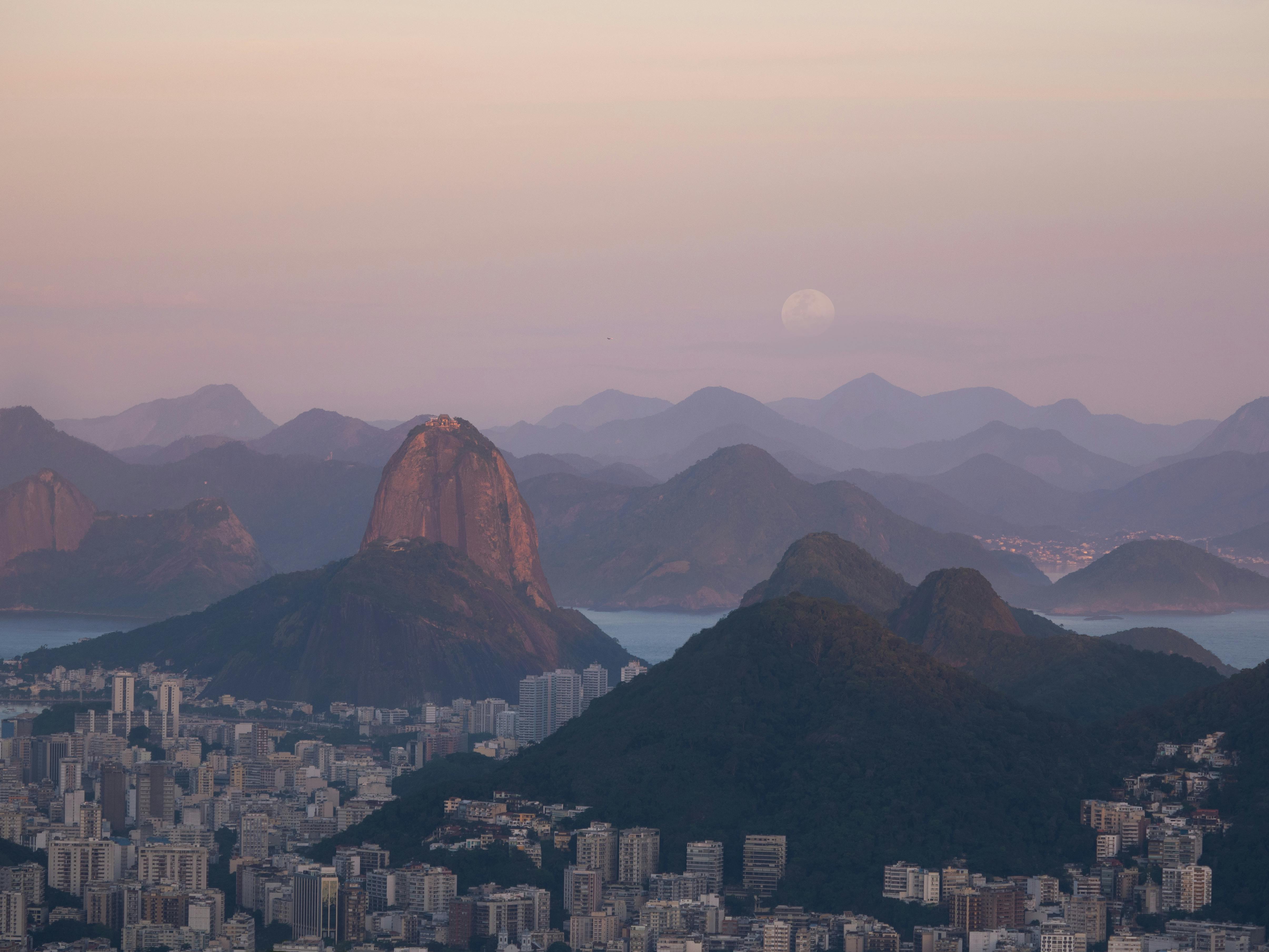 A stunning aerial view of Rio de Janeiro's cityscape with Sugarloaf Mountain at dusk.