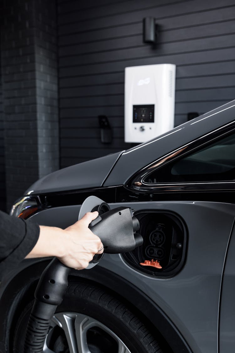 Person Holding Car Electric Charger