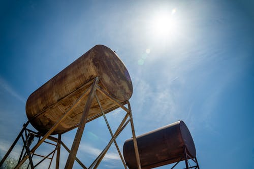 Low Angle Shot of Industrial Containers against Blue Sky