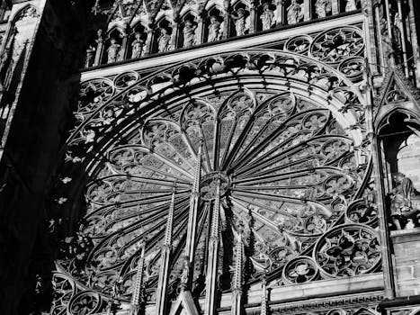Close-up of the ornamental Gothic architecture of Strasbourg Cathedral's rose window.
