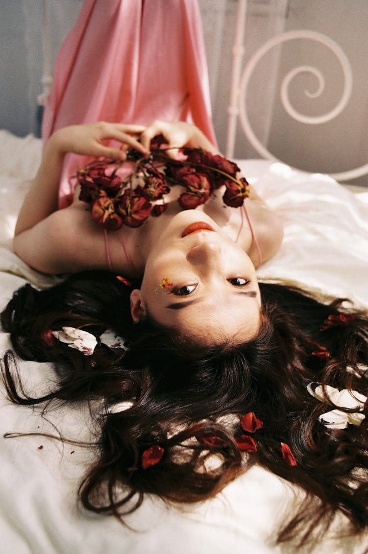 Brunette Beauty In Pink Nighty Cuddling Red Dried Flowers