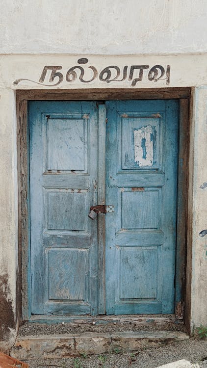 Blue Wooden Door on White Concrete Wall