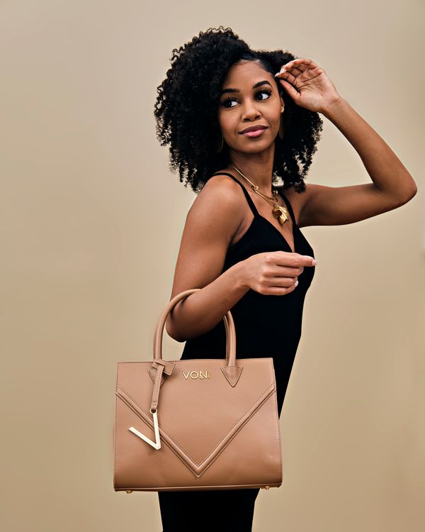 Beautiful Woman in Black Dress Holding a Bag · Free Stock Photo