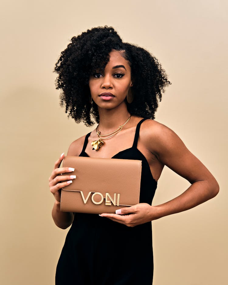 Woman With Handbag Posing In Studio