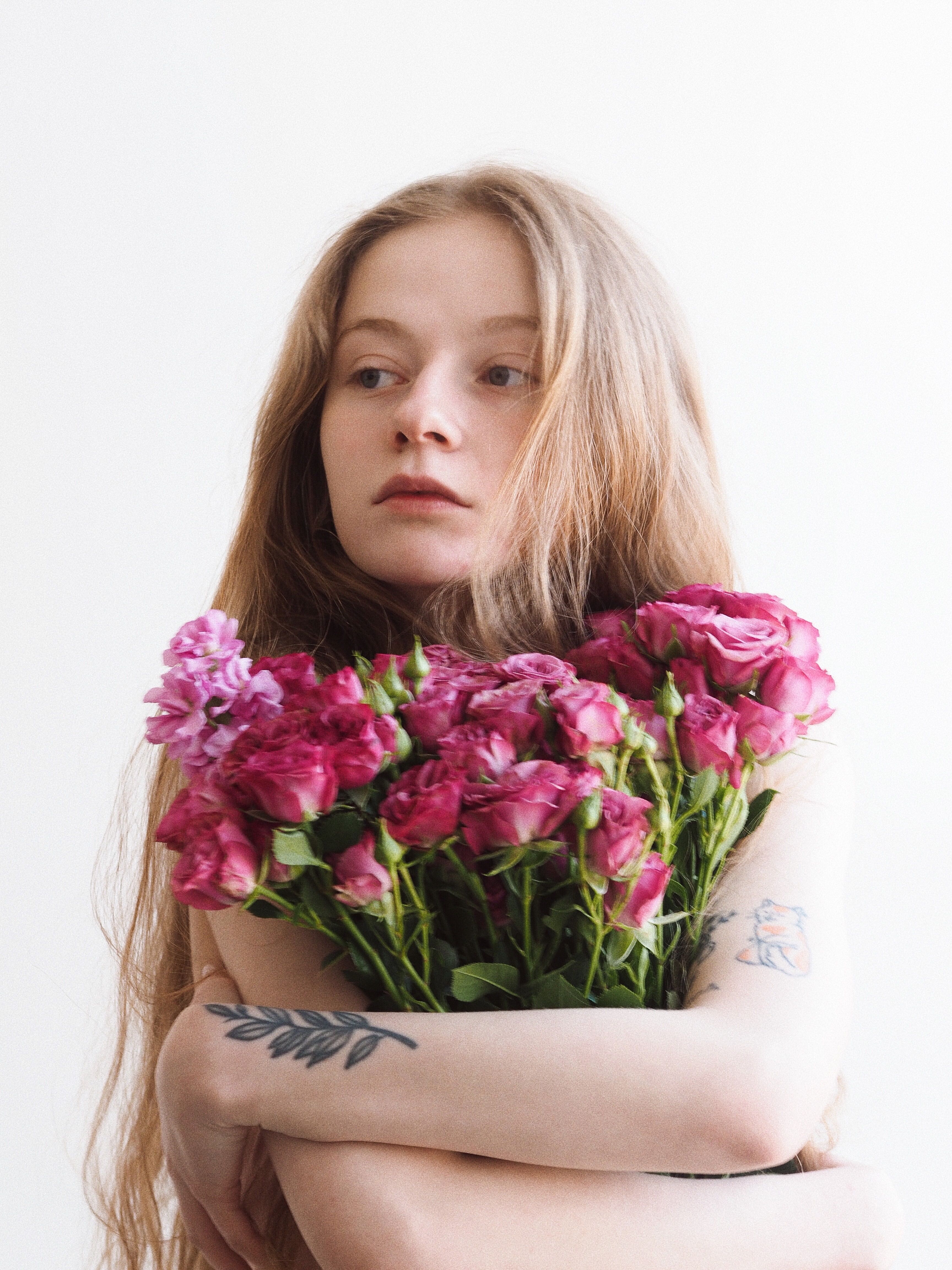 Woman Holding a Bunch of Pink Roses · Free Stock Photo