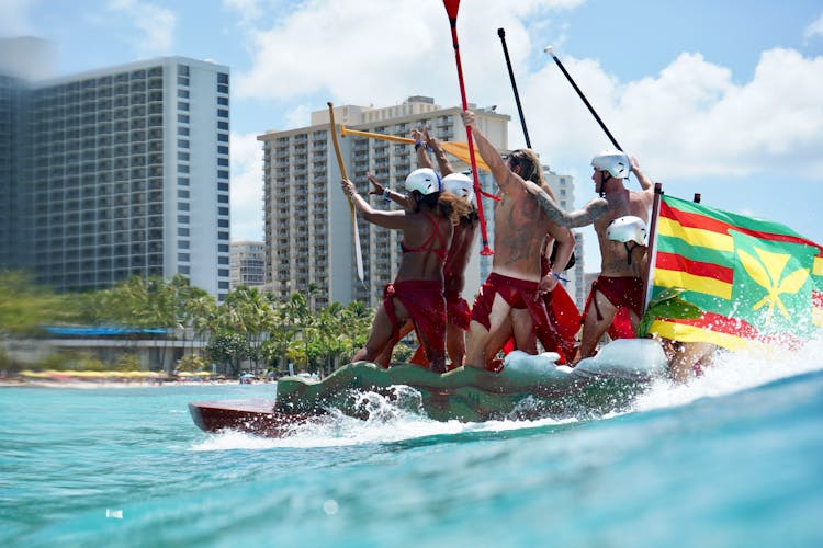 People Having Fun Sailing On Boat In Sea