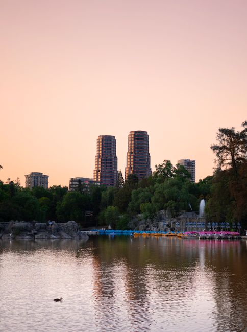 Twilight view of Chapultepec Park with skyline and lake in Mexico City.