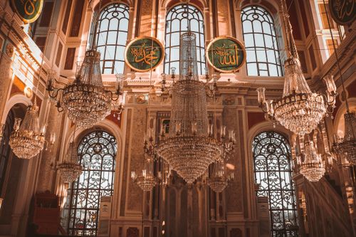 Free Ornate mosque interior featuring exquisite chandeliers and traditional Islamic architecture. Stock Photo