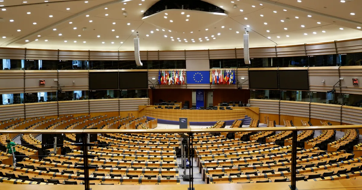 The empty hemicycle of the European Parliament with rows of seats under a curved ceiling, representing GDPR Article 30 requires written records of all personal data processing activities including AI tools