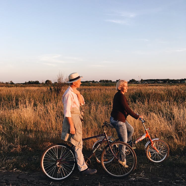 Man And Woman Riding Bicycles Together