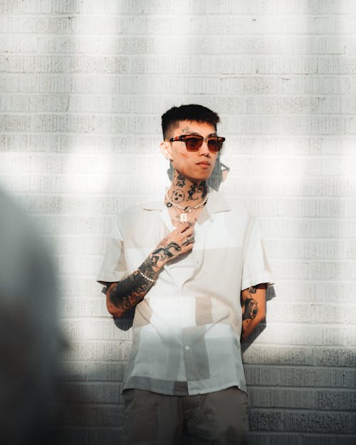 Young Man with Tattoos and Sunglasses