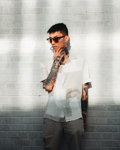 Young Man with Tattoos and Sunglasses
