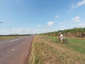 Person in White Long Sleeve Shirt Walking with Bicycle