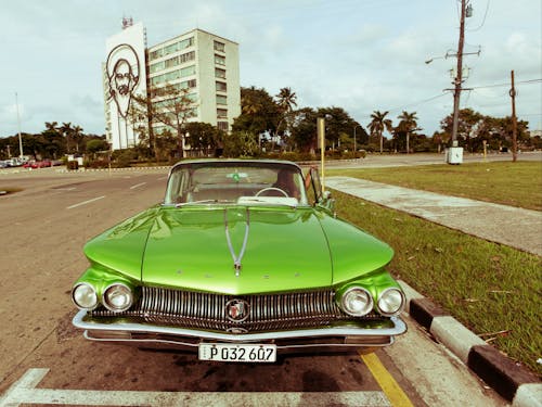 Free Green Classic Car Parked on Side of the Road Stock Photo