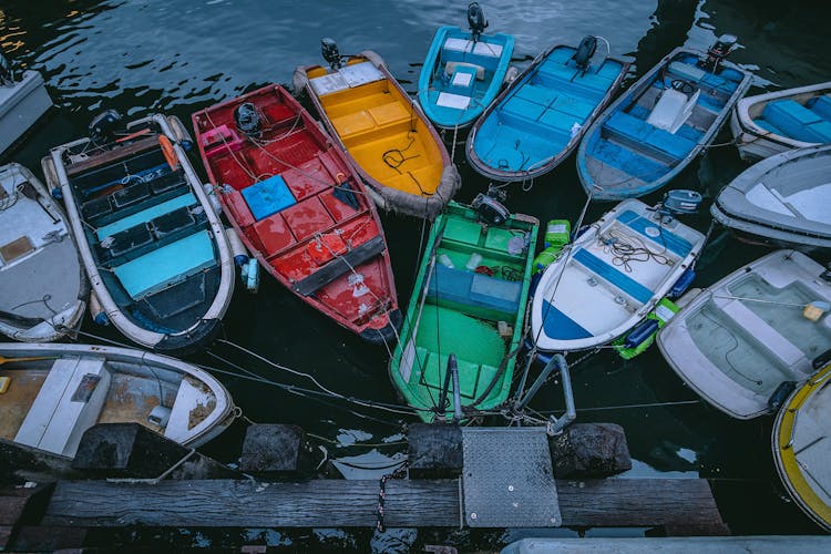 Boats Moored On Wooden Posts