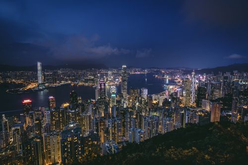 Free Aerial view of Hong Kong's vibrant skyline at night, featuring illuminated skyscrapers and city lights. Stock Photo