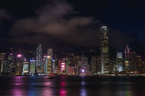 Free Illuminated Hong Kong skyline and Victoria Harbour at night showcasing skyscrapers. Stock Photo