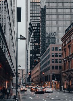 Dynamic urban scene capturing city life amidst towering modern skyscrapers.