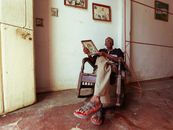 Man in Black Shirt  Sitting on Wooden Rocking Chair