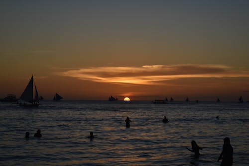 Silhouette of People at Sea during Sunset