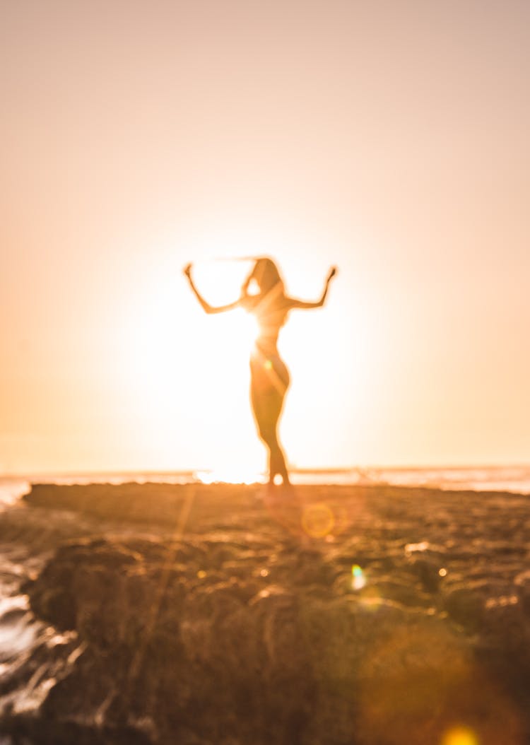 Silhouette Of Woman Near Cliff