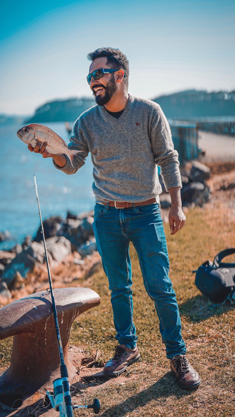 Smiling Man Holding A Fish