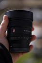 Person Holding Black Camera Lens