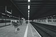 Monochrome view of commuters at Den Haag Centraal Station, Netherlands.