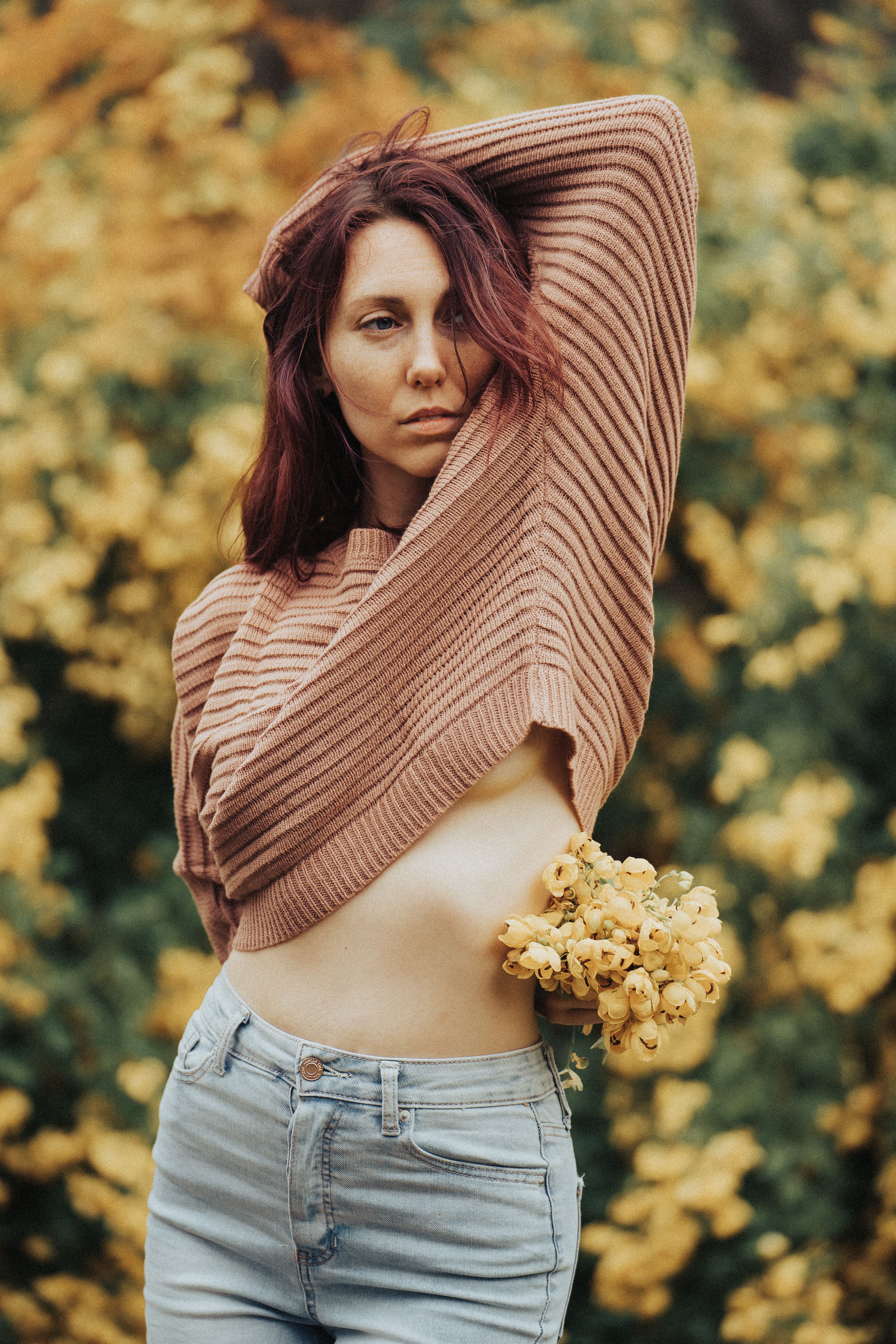 Woman in brown sweater and blue denim jeans
